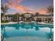 Resort-style pool with clubhouse at sunset at 8678 Rain Song Rd, Sarasota, FL 34238