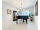 Elegant dining room featuring a grand piano and chandelier at 8678 Rain Song Rd, Sarasota, FL 34238
