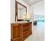 Stylish foyer with a marble-topped cabinet, decorative mirror, and views of the kitchen at 8678 Rain Song Rd, Sarasota, FL 34238
