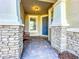 Covered front porch with stone details at 8678 Rain Song Rd, Sarasota, FL 34238