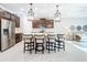 Spacious kitchen with pendant lights, stainless appliances, and a large center island with barstools at 8678 Rain Song Rd, Sarasota, FL 34238