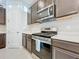 Stainless steel appliances and dark cabinets at 8678 Rain Song Rd, Sarasota, FL 34238