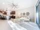 Bright living room featuring a ceiling fan, neutral colors, and sliding doors to the outside at 8678 Rain Song Rd, Sarasota, FL 34238