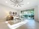 Bright living room with sliding glass doors opening to the lanai and backyard at 8678 Rain Song Rd, Sarasota, FL 34238