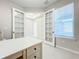 Home office with built-in shelving and French doors at 8678 Rain Song Rd, Sarasota, FL 34238