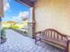 Brick walkway with bench, leading to home at 8678 Rain Song Rd, Sarasota, FL 34238
