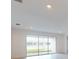 Living room with sliding glass doors and view of lake at 1575 Laurel Brook Ln, Port Charlotte, FL 33953