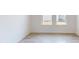 Spacious bedroom with two windows and light grey wood-look tile floor at 16113 Old Fox Trl, Port Charlotte, FL 33953
