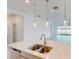 Modern kitchen island with double sink and stainless steel faucet at 16113 Old Fox Trl, Port Charlotte, FL 33953