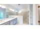 Elegant bathroom with dual vanity, large mirror, and walk-in shower at 16113 Old Fox Trl, Port Charlotte, FL 33953