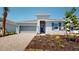 A charming new home with gray exterior and a brick driveway at 16113 Old Fox Trl, Port Charlotte, FL 33953