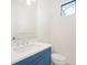 Small powder room with blue vanity and white toilet at 524 Bocelli Dr, North Venice, FL 34275