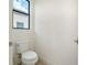 Clean powder room features a toilet and a window, offering natural light at 524 Bocelli Dr, North Venice, FL 34275