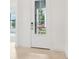 Front entry with neutral tile floor and white door at 524 Bocelli Dr, North Venice, FL 34275