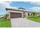 Two-story home with modern design and a stone facade at 524 Bocelli Dr, North Venice, FL 34275