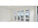 Bright bedroom with sliding doors to a patio and lake view at 524 Bocelli Dr, North Venice, FL 34275