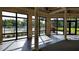 Bright clubhouse room featuring large windows, pillars, and views of the outdoor pool and landscaping at 8047 Victoria Falls Cir, Sarasota, FL 34243