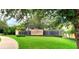 Lakeridge Falls community entrance with stone signage, lush landscaping, and a serene waterfall feature at 8047 Victoria Falls Cir, Sarasota, FL 34243