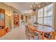 Inviting dining room boasts natural light, a decorative chandelier, and charming office space beyond at 8047 Victoria Falls Cir, Sarasota, FL 34243