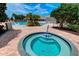Community hot tub with clear blue water, adjacent to the pool and lush landscaping at 8047 Victoria Falls Cir, Sarasota, FL 34243