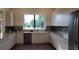 Kitchen featuring white cabinetry, granite countertops, stainless steel appliances, and natural light at 8047 Victoria Falls Cir, Sarasota, FL 34243