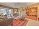 Comfortable living room featuring a ceiling fan, built-in shelving, and lots of natural light at 8047 Victoria Falls Cir, Sarasota, FL 34243