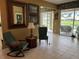 Inviting living room features tile floors, elegant decor, and a view of the lake at 8047 Victoria Falls Cir, Sarasota, FL 34243