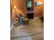 Cozy living room featuring a comfortable armchair and footstool with wood-look floors at 8047 Victoria Falls Cir, Sarasota, FL 34243
