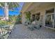 Tranquil screened-in patio with comfortable seating, tropical plants, and outdoor relaxation space at 8047 Victoria Falls Cir, Sarasota, FL 34243