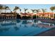 Community pool featuring a clear blue surface and shaded seating areas for relaxation and enjoyment at 8047 Victoria Falls Cir, Sarasota, FL 34243