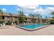 Community pool with lounge chairs and a surrounding patio at 370 Three Lakes Ln # F, Venice, FL 34285