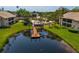 Aerial view of community pool, dock, and lush landscaping at 370 Three Lakes Ln # F, Venice, FL 34285