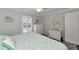 King bedroom with white dresser and large mirror at 370 Three Lakes Ln # F, Venice, FL 34285