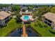 Community pool and dock with lush landscaping, perfect for relaxing at 370 Three Lakes Ln # F, Venice, FL 34285