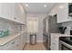 Modern kitchen with stainless steel appliances and white cabinets at 370 Three Lakes Ln # F, Venice, FL 34285