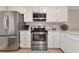 Modern kitchen with stainless steel appliances and white cabinets at 370 Three Lakes Ln # F, Venice, FL 34285