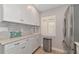 Modern kitchen with stainless steel appliances and white cabinets at 370 Three Lakes Ln # F, Venice, FL 34285