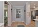 Bright entryway with view of kitchen and bedroom at 370 Three Lakes Ln # F, Venice, FL 34285