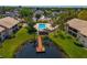 Community pool and dock with lush landscaping, perfect for relaxing at 370 Three Lakes Ln # F, Venice, FL 34285