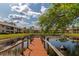 Peaceful pond with a wooden dock for relaxing at 370 Three Lakes Ln # F, Venice, FL 34285