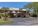 Building exterior showcasing covered parking and landscaping at 370 Three Lakes Ln # F, Venice, FL 34285