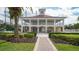 Two-story clubhouse with a red tile roof, multiple windows and a wrap-around porch at 401 N Point Rd # 301, Osprey, FL 34229