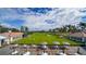 Outdoor patio area with tables, umbrellas, and a view of the golf course at 401 N Point Rd # 301, Osprey, FL 34229