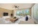 Bright living room with balcony access and treetop views at 401 N Point Rd # 301, Osprey, FL 34229