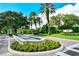 Gated entrance to The Oaks Reserve, featuring a fountain and landscaping at 401 N Point Rd # 301, Osprey, FL 34229