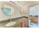 Double vanity bathroom with granite countertops and updated fixtures at 5372 Pamela Wood Way # 7, Sarasota, FL 34233
