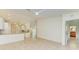 Open living room and kitchen with vaulted ceilings and tile floors at 5372 Pamela Wood Way # 7, Sarasota, FL 34233