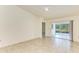Living room with tiled floors, sliding doors to patio at 5372 Pamela Wood Way # 7, Sarasota, FL 34233