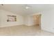 Bright living room with tile floors and a view of the kitchen at 5372 Pamela Wood Way # 7, Sarasota, FL 34233