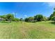 Landscaped backyard with pond view at 5372 Pamela Wood Way # 7, Sarasota, FL 34233